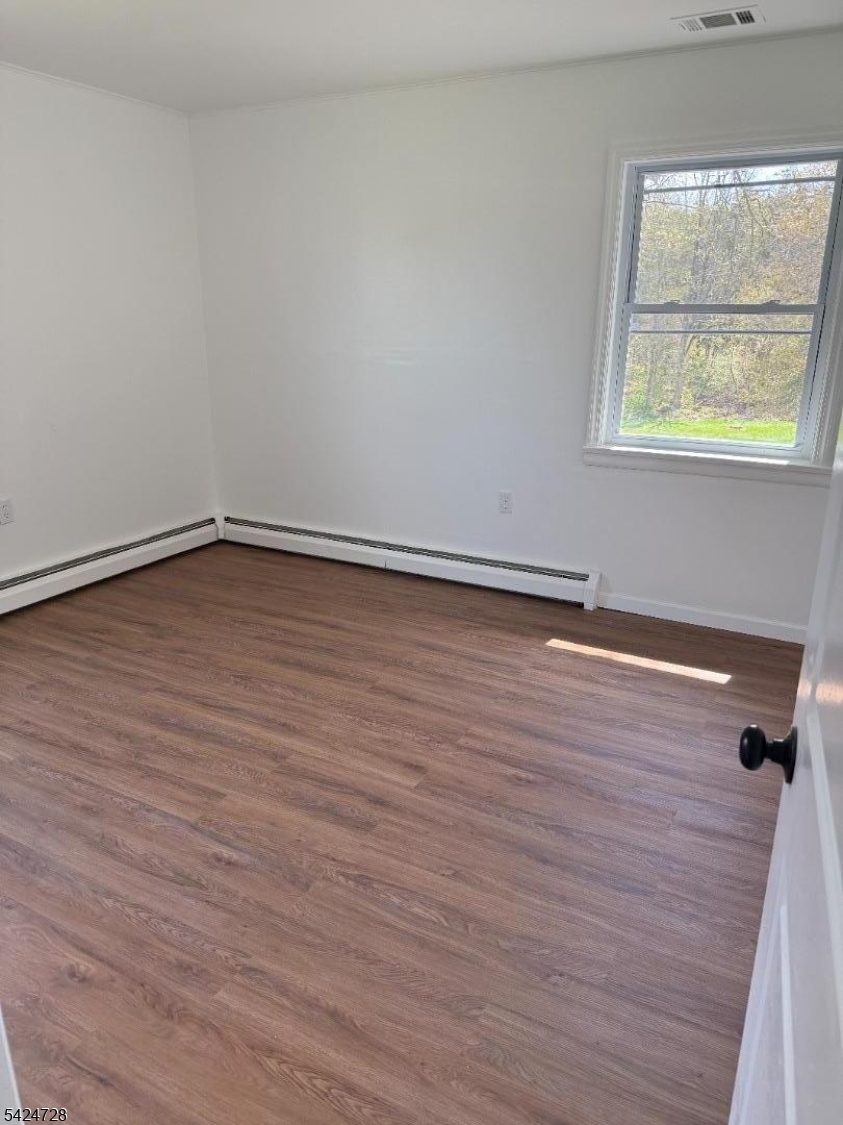 80 Gates Road Somerset, NJ 08873 - Photo 11 of 17 a view of an empty room with wooden floor and a window
