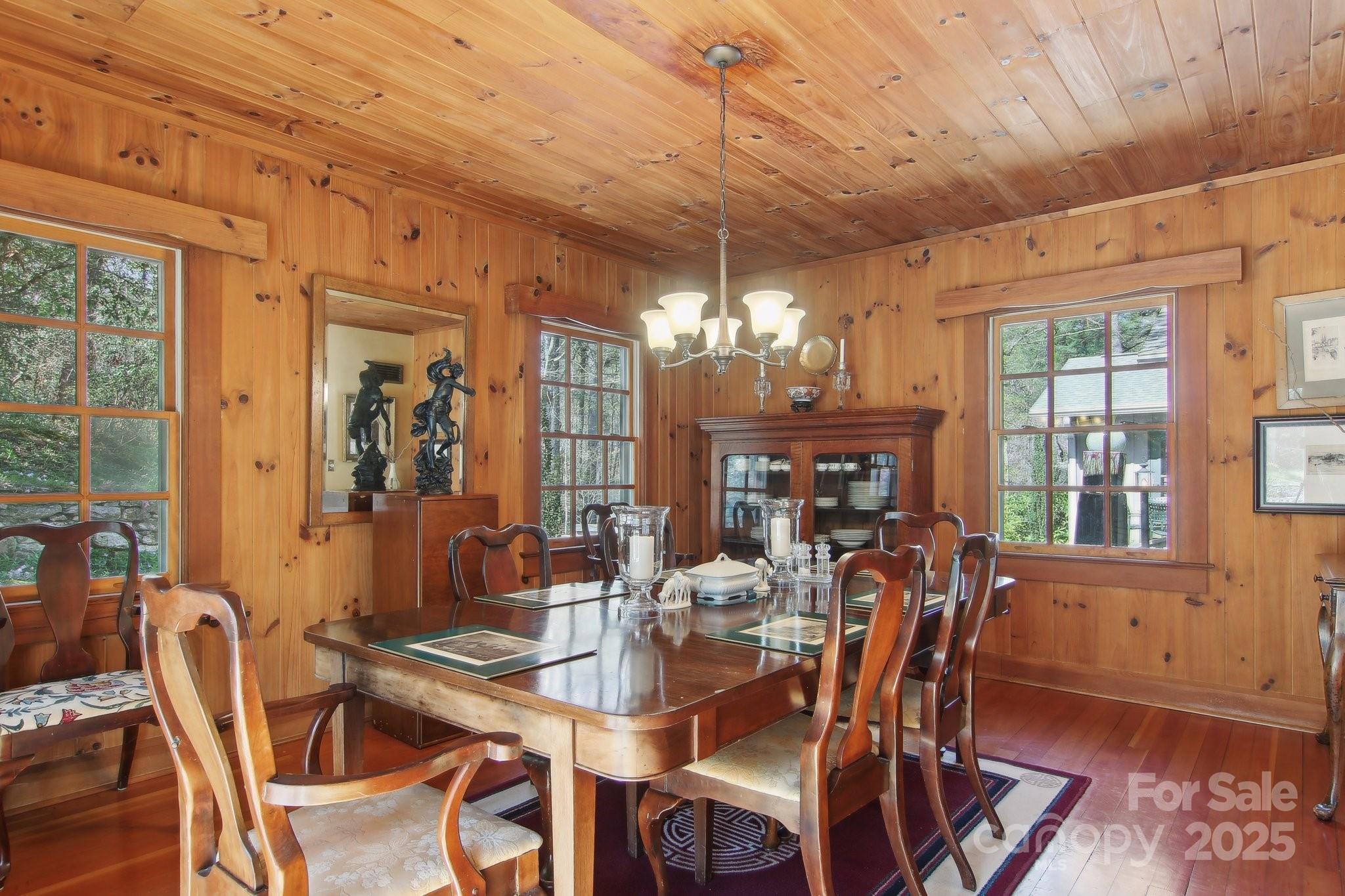 798 Evans Road Hendersonville, NC 28739 - Photo 15 of 45 a view of a dining room with furniture a chandelier and wooden floor