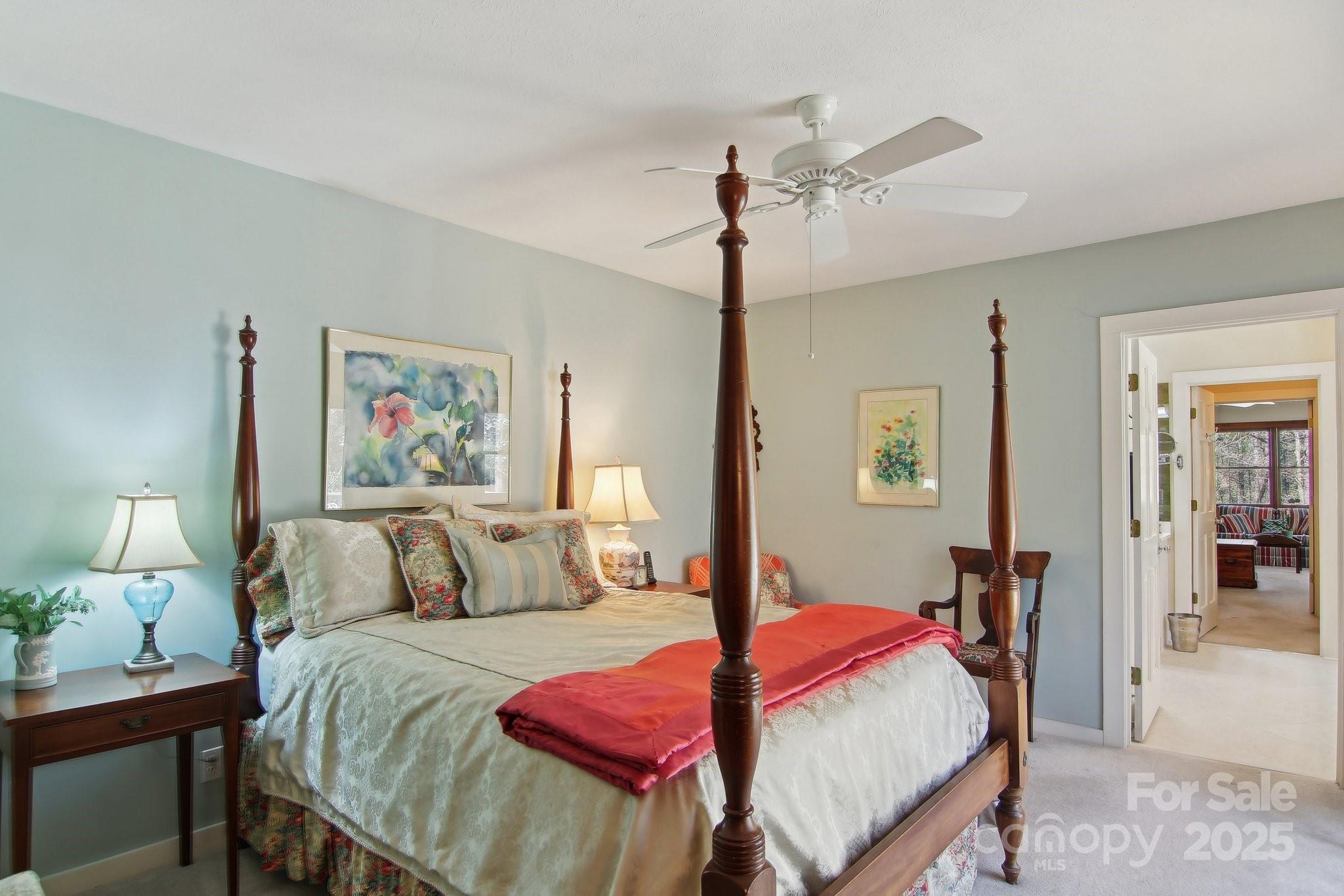 798 Evans Road Hendersonville, NC 28739 - Photo 18 of 45 a bedroom with a bed and a chandelier