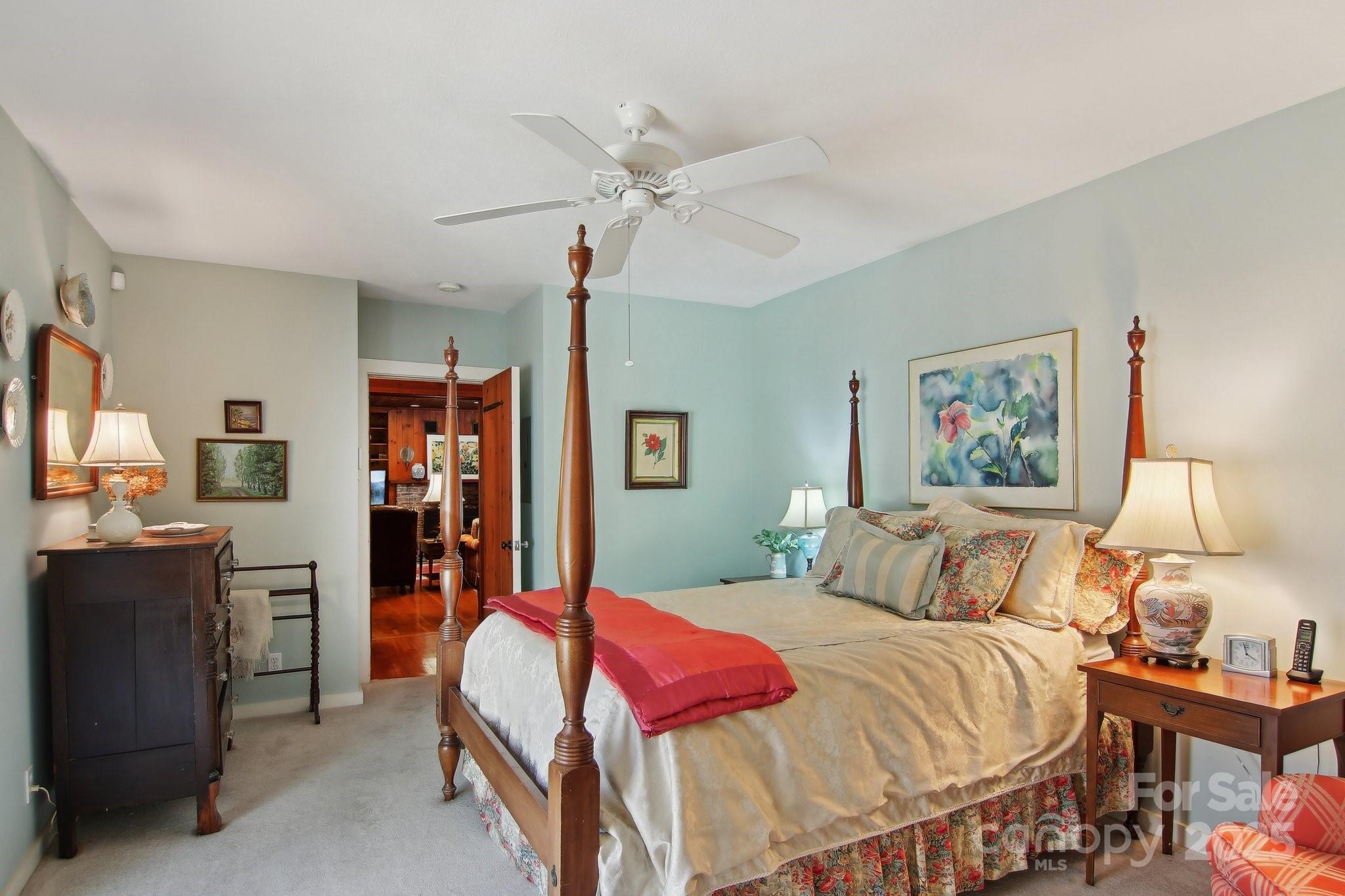 798 Evans Road Hendersonville, NC 28739 - Photo 19 of 45 a bedroom with a bed and a chandelier