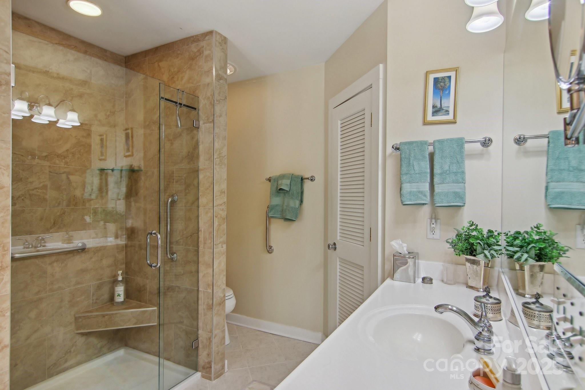 798 Evans Road Hendersonville, NC 28739 - Photo 21 of 45 a bathroom with a tub shower and mirror
