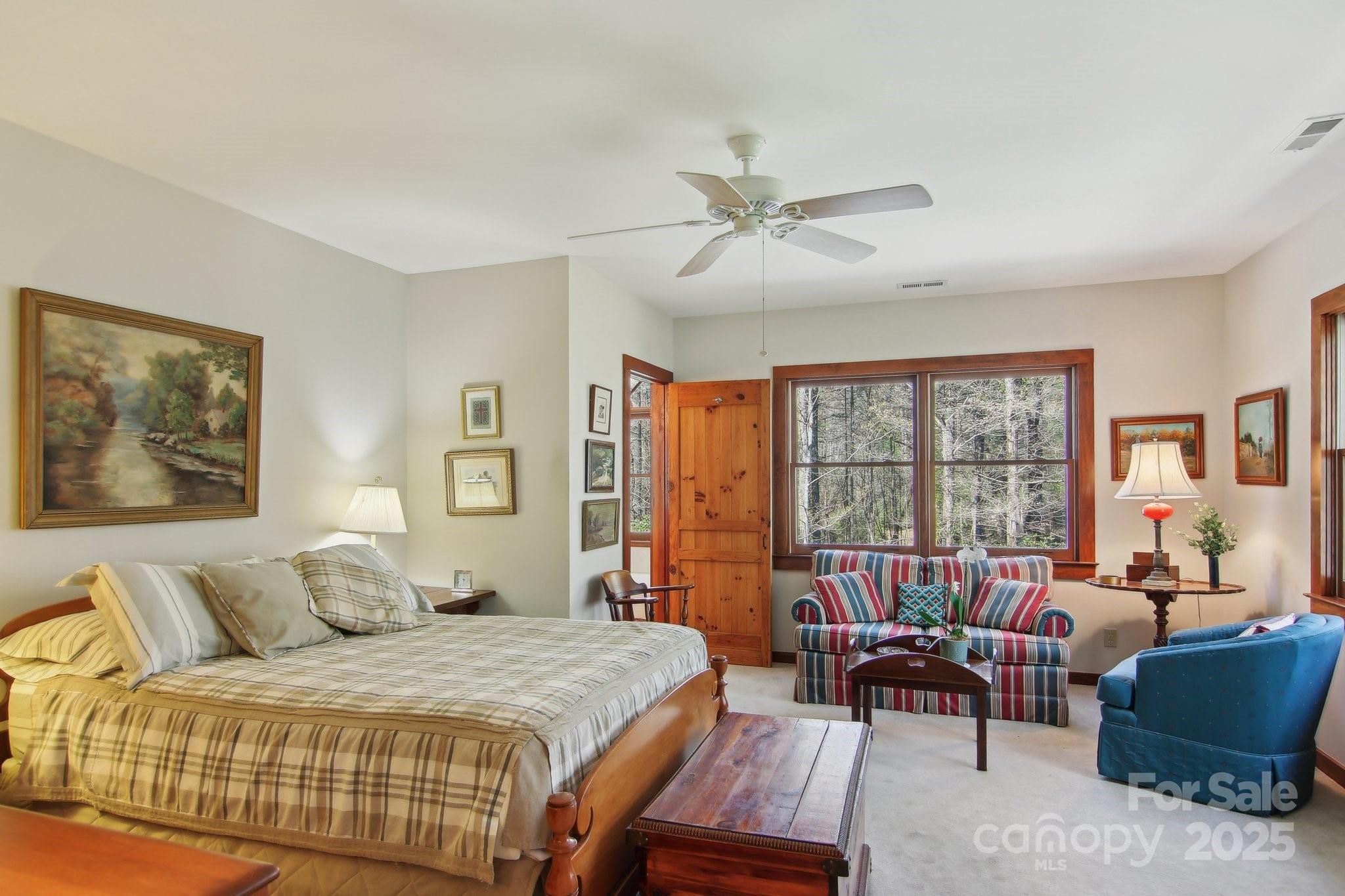 798 Evans Road Hendersonville, NC 28739 - Photo 22 of 45 a spacious bedroom with a bed a couch and a window