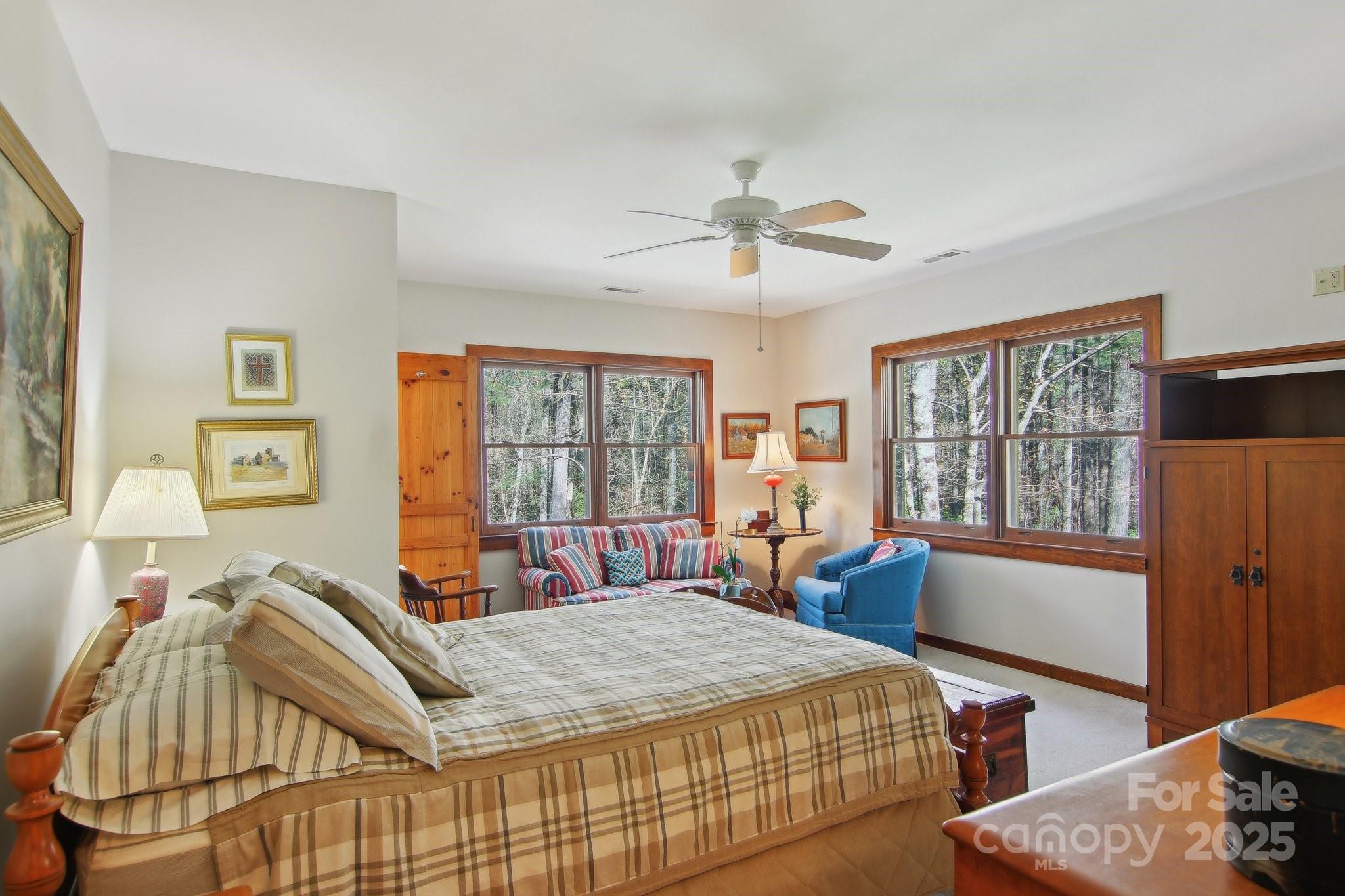 798 Evans Road Hendersonville, NC 28739 - Photo 23 of 45 a bedroom with a bed and wooden floor