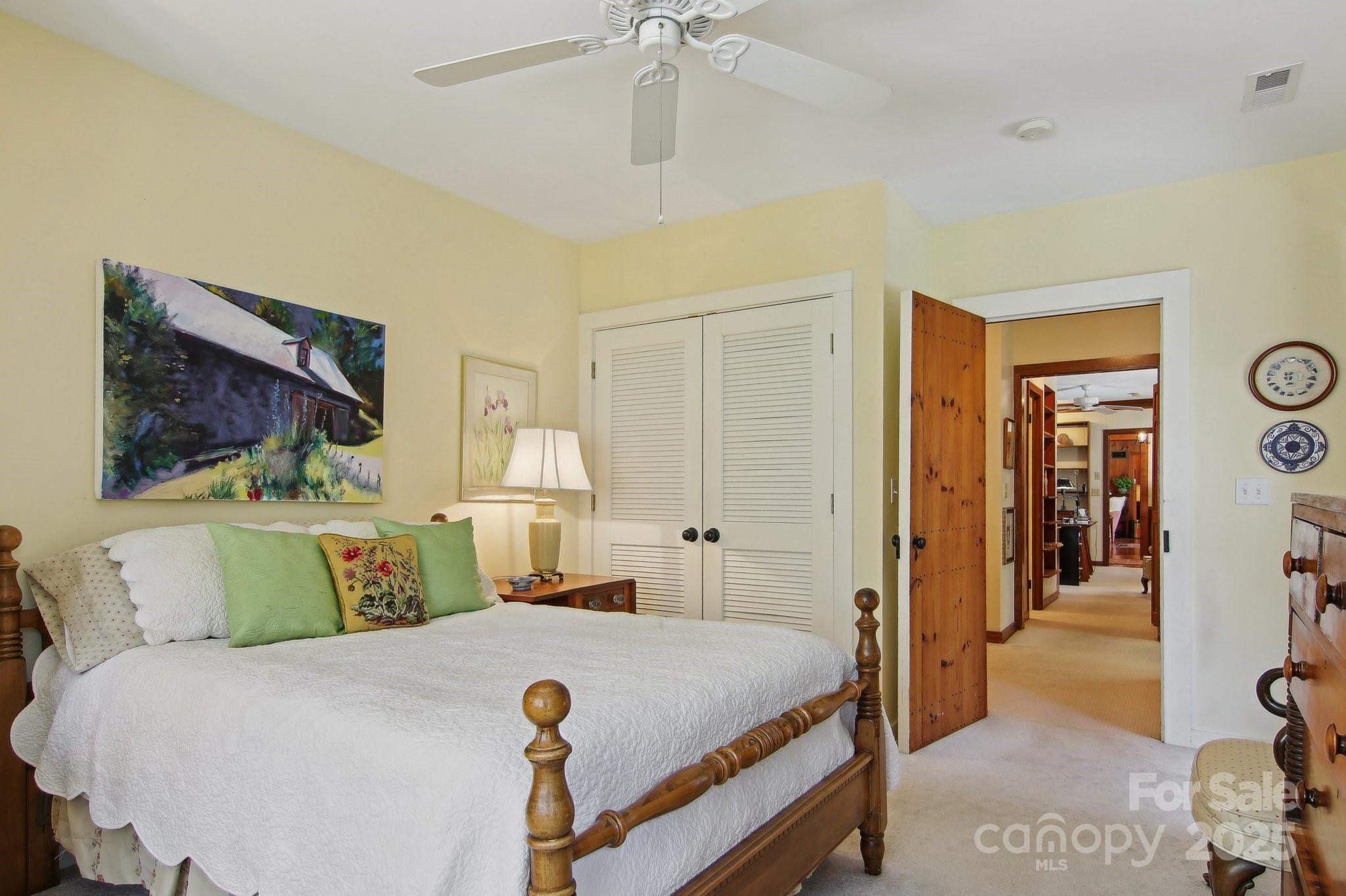 798 Evans Road Hendersonville, NC 28739 - Photo 26 of 45 a bedroom with a large bed and a chandelier