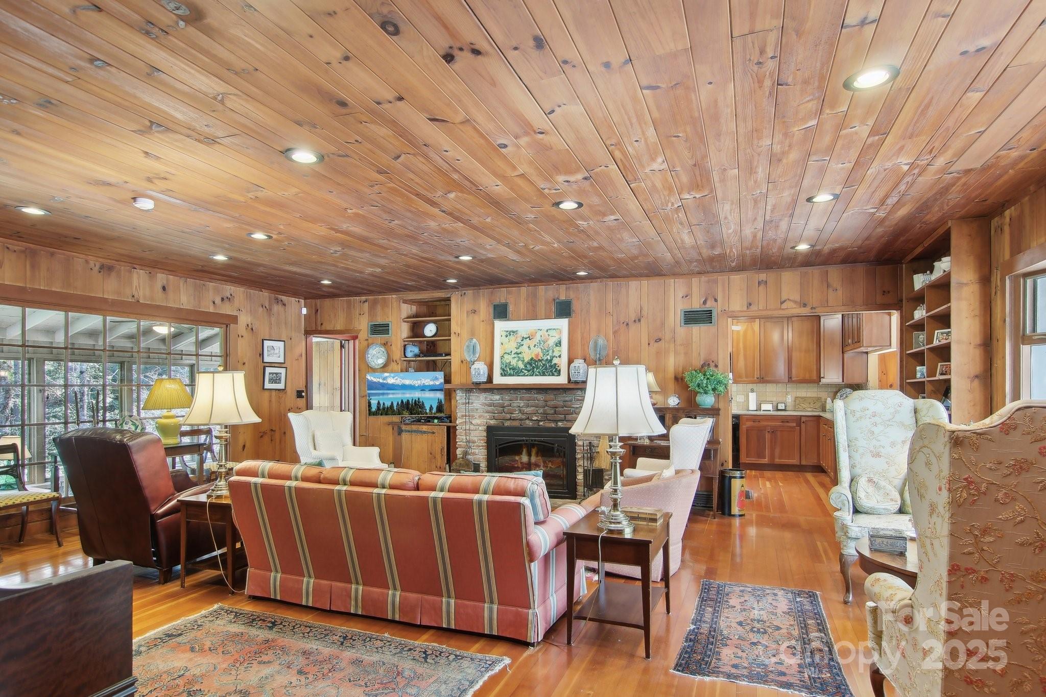 798 Evans Road Hendersonville, NC 28739 - Photo 3 of 45 a living room with furniture a fireplace and wooden floor