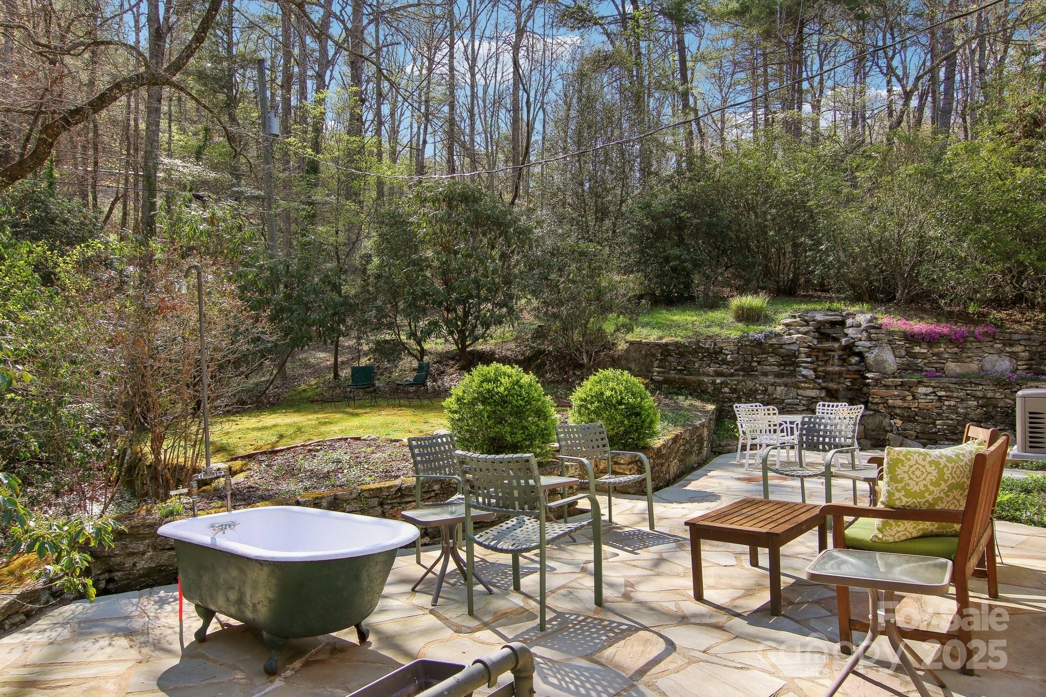 798 Evans Road Hendersonville, NC 28739 - Photo 31 of 45 a view of a swimming pool with lawn chairs under an umbrella