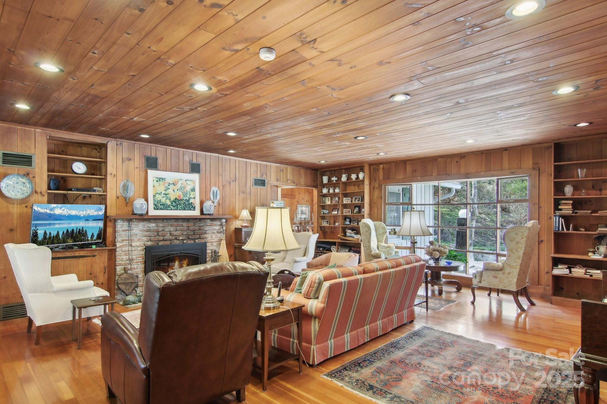 798 Evans Road Hendersonville, NC 28739 - Photo 5 of 45 a living room with fireplace furniture and a floor to ceiling window