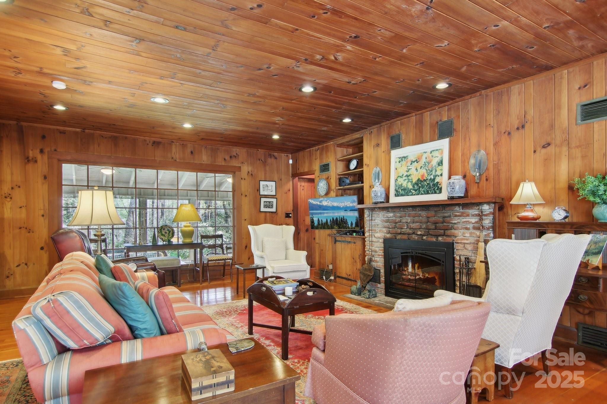 798 Evans Road Hendersonville, NC 28739 - Photo 6 of 45 a living room with furniture a fireplace and a flat screen tv