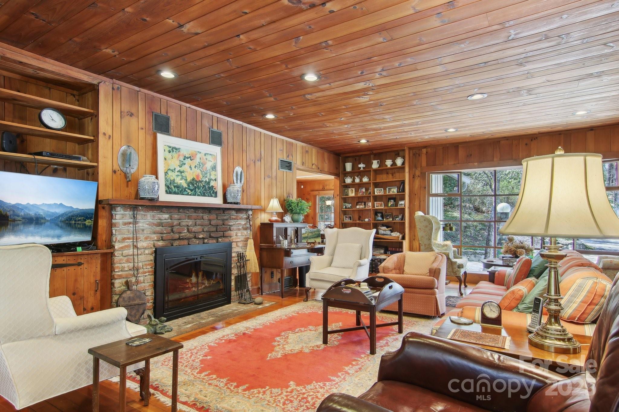 798 Evans Road Hendersonville, NC 28739 - Photo 7 of 45 a living room with furniture a fireplace and a table