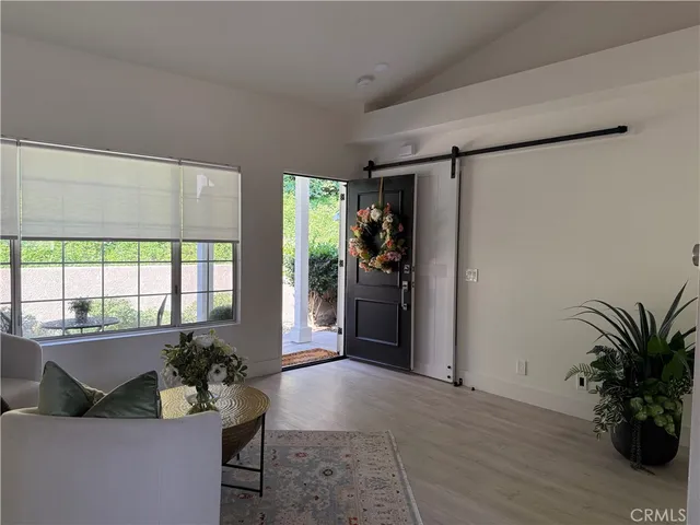 a living room with furniture and a potted plant