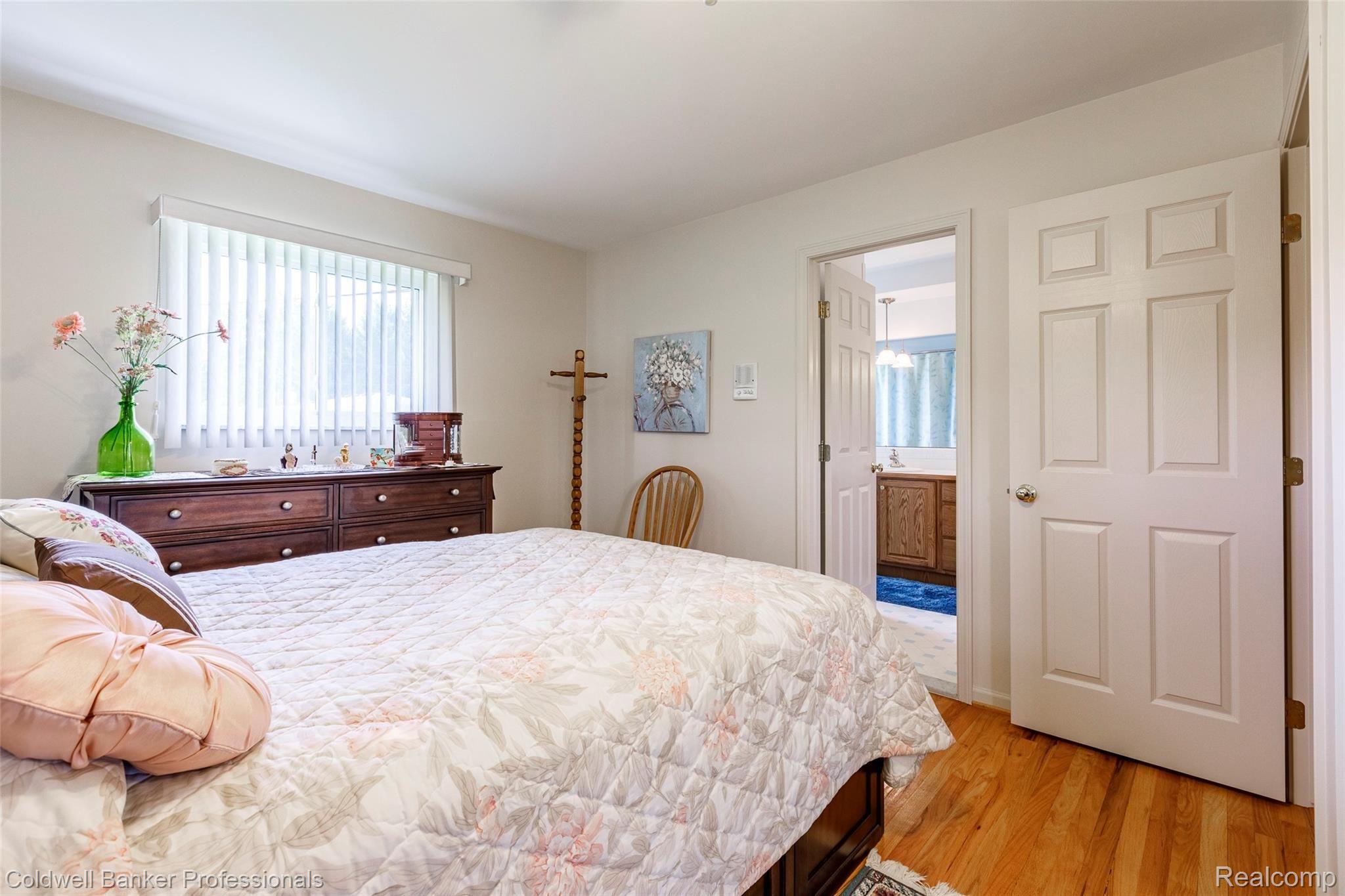 6945 Hubbard Road Clarkston, MI 48348 - Photo 6 of 22 Large master bedroom with natural light and wood floors