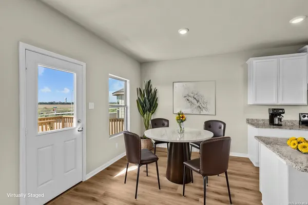 a view of a dining room with furniture window and wooden floor