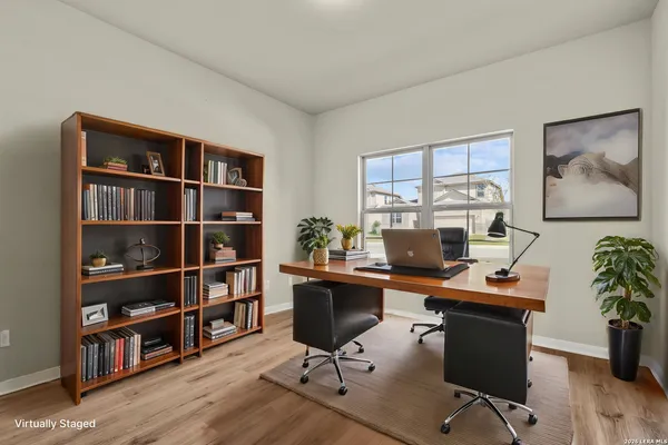 a view of a workspace with furniture and a bookshelf