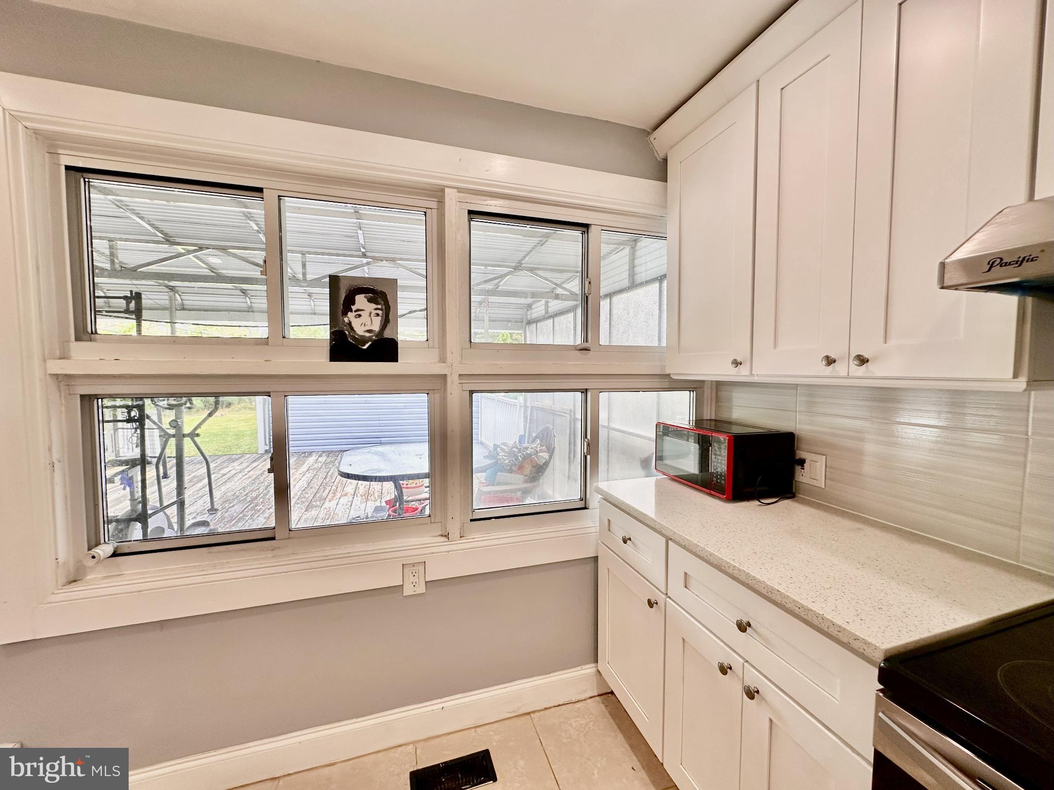 632 Durham Road Newtown, PA 18940 - Photo 11 of 36 a kitchen with white cabinets and a window