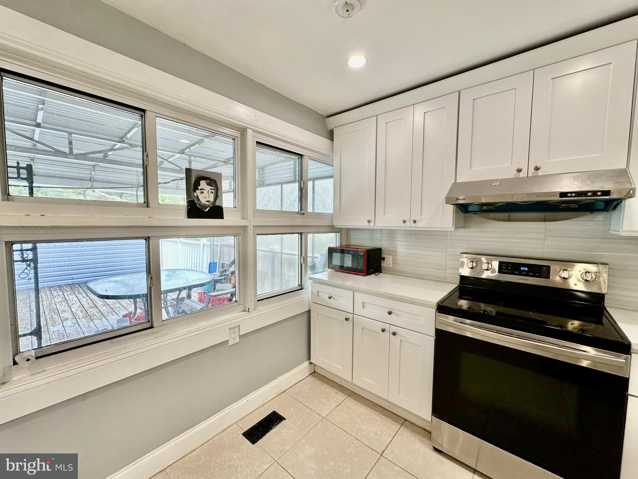 632 Durham Road Newtown, PA 18940 - Photo 9 of 36 a kitchen with stainless steel appliances granite countertop white cabinets and window