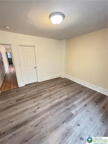 a view of room with wooden floor