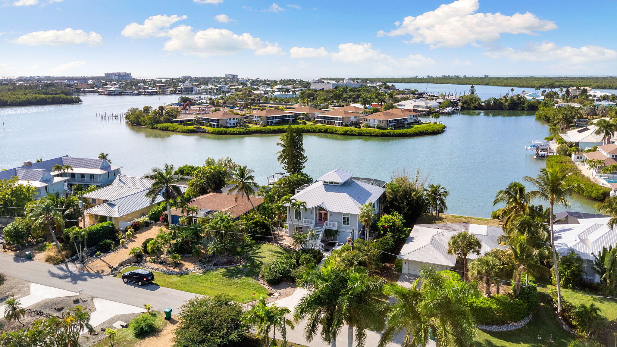 418 Panay Avenue Naples, FL 34113 - Photo 22 of 53 a view of a lake with a city
