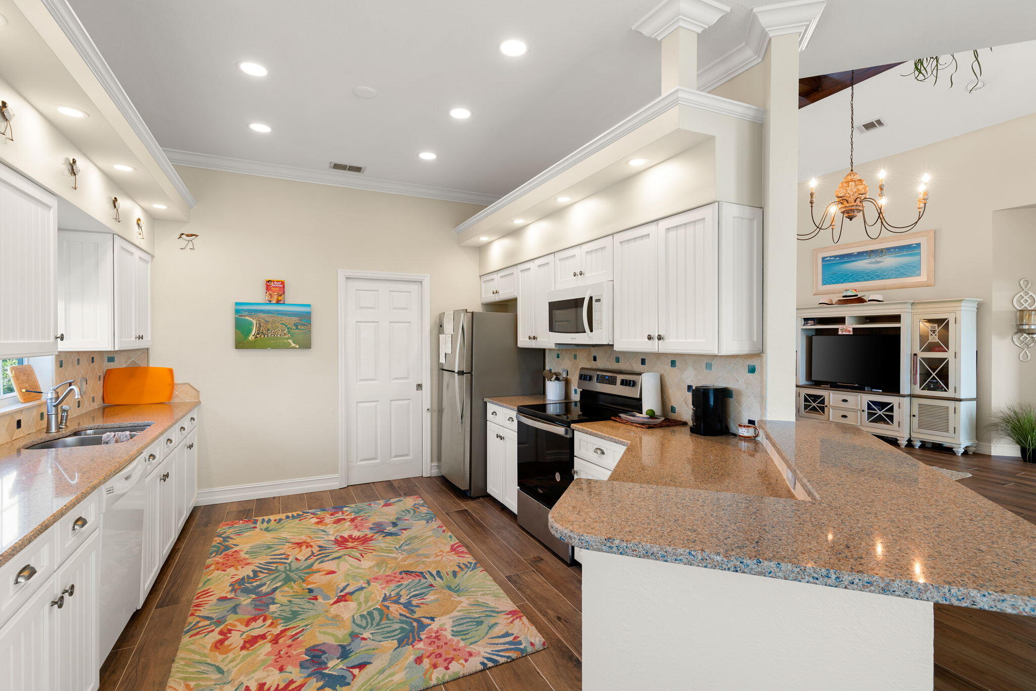 418 Panay Avenue Naples, FL 34113 - Photo 28 of 53 a kitchen with stainless steel appliances granite countertop a sink stove and refrigerator