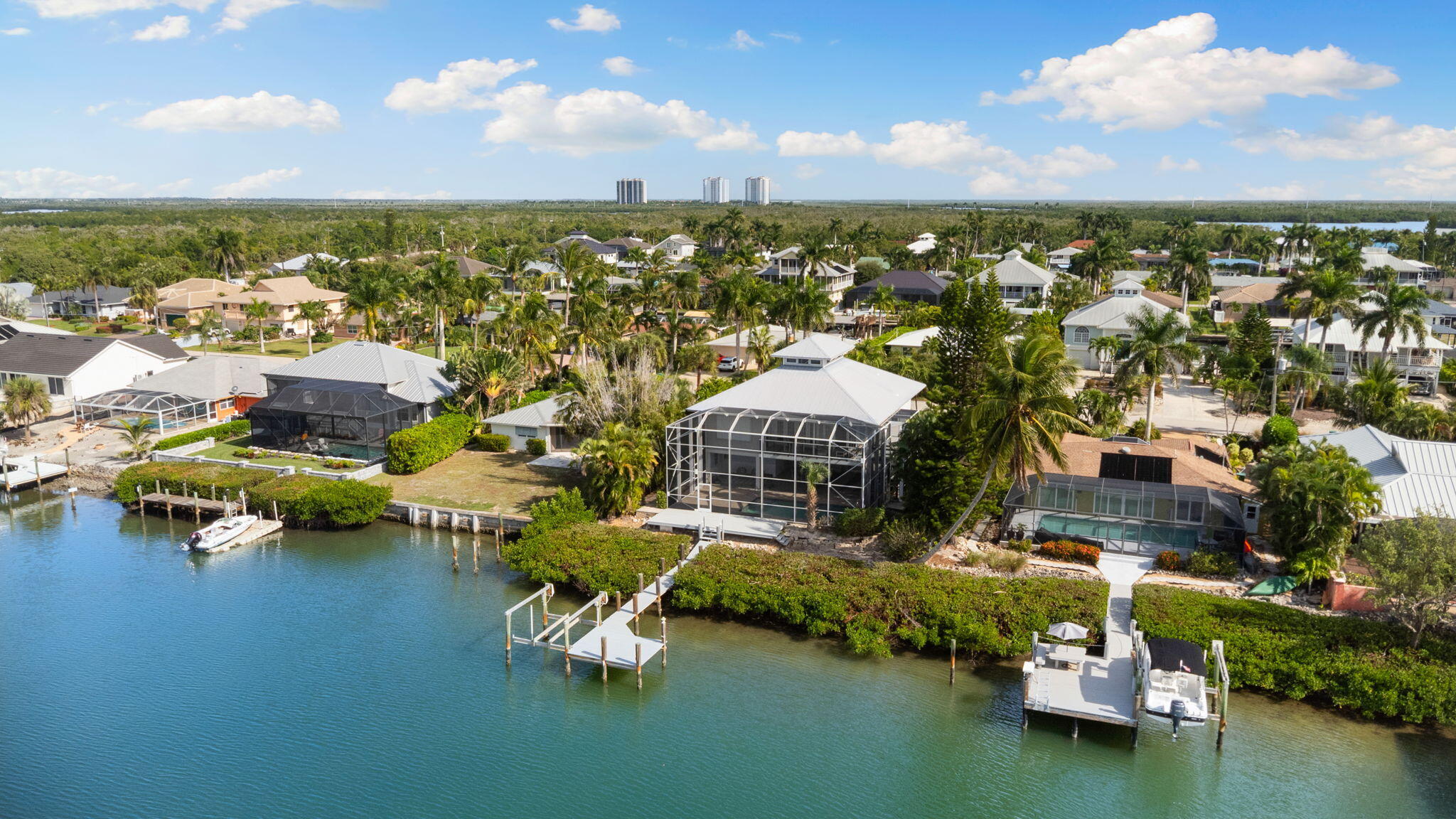 418 Panay Avenue Naples, FL 34113 - Photo 31 of 53 a view of a lake with building in front of it