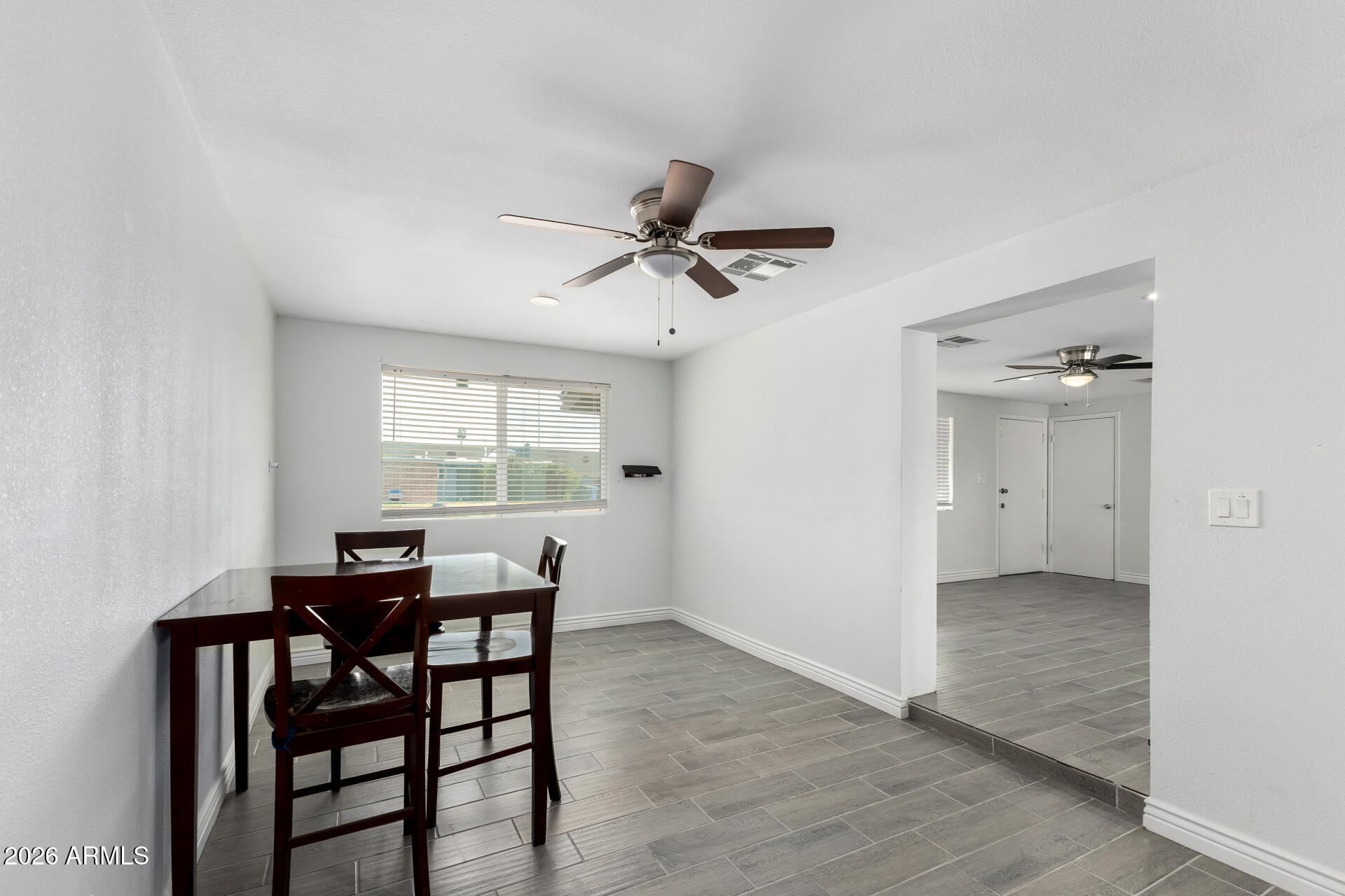 14616 North Ensenada Court Phoenix, AZ 85053 - Photo 12 of 23 a view of a dining room with furniture and a window