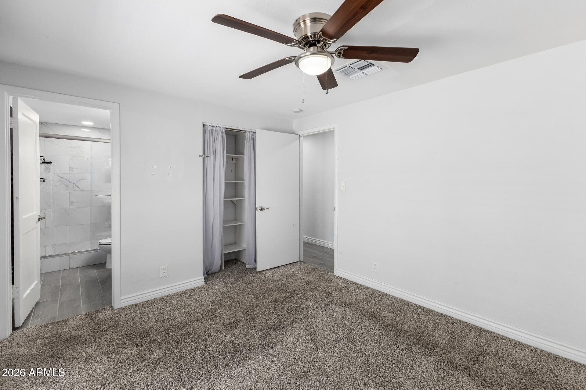 14616 North Ensenada Court Phoenix, AZ 85053 - Photo 14 of 23 an empty room with closet and windows