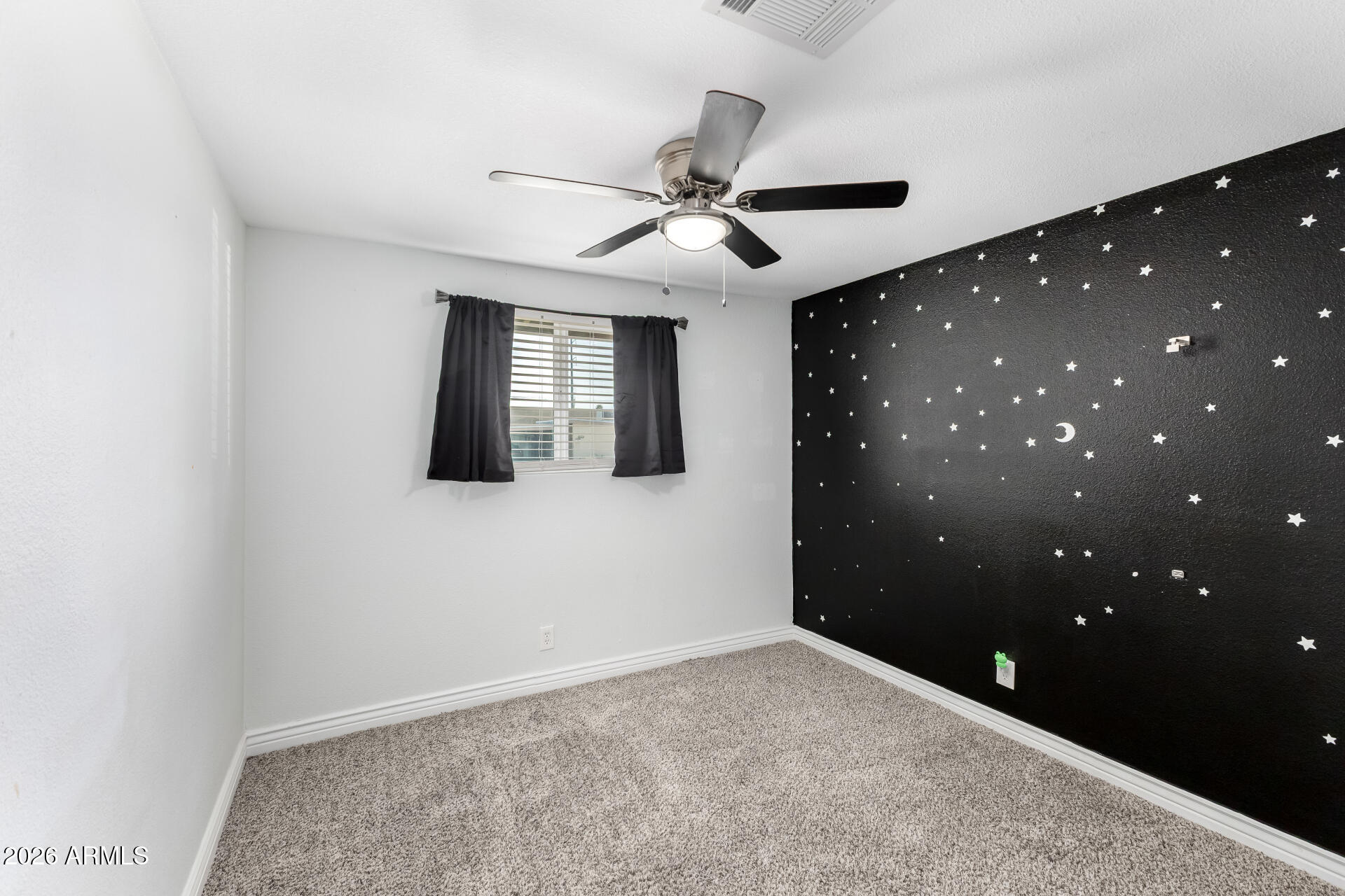 14616 North Ensenada Court Phoenix, AZ 85053 - Photo 16 of 23 a view of an empty room with a ceiling fan