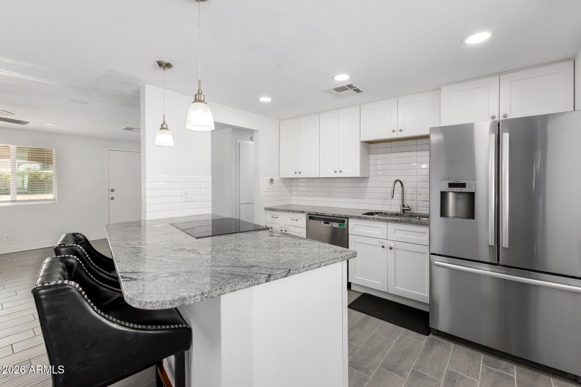 14616 North Ensenada Court Phoenix, AZ 85053 - Photo 10 of 23 a kitchen with granite countertop a sink appliances cabinets and furniture