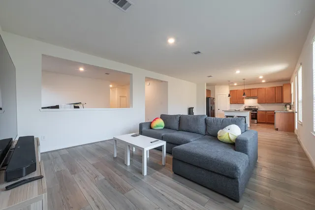 a living room with furniture and wooden floor