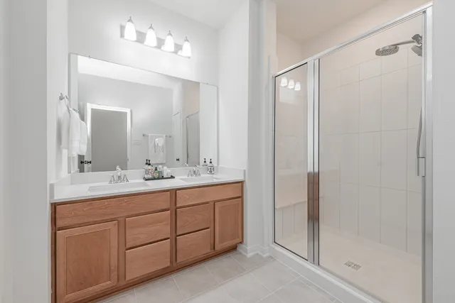 a bathroom with a double vanity sink and mirror
