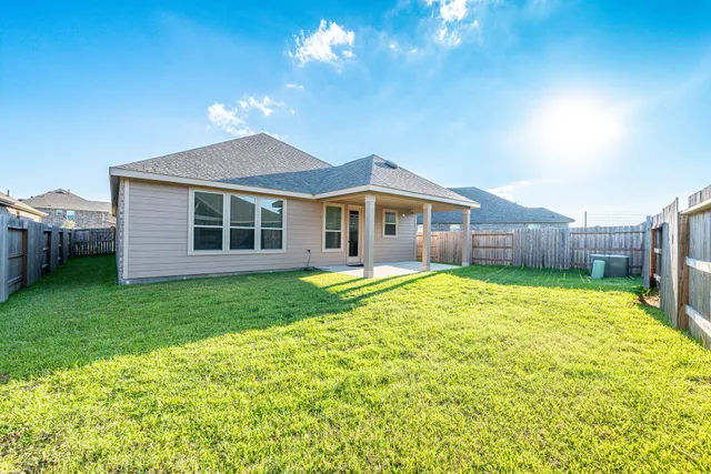 a view of a house with a backyard