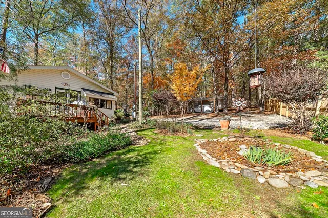 a backyard of a house with a yard and outdoor seating