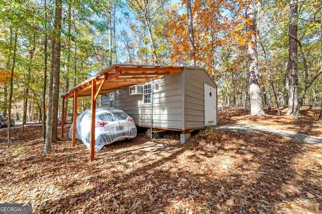 a view of a yard with plants and trees