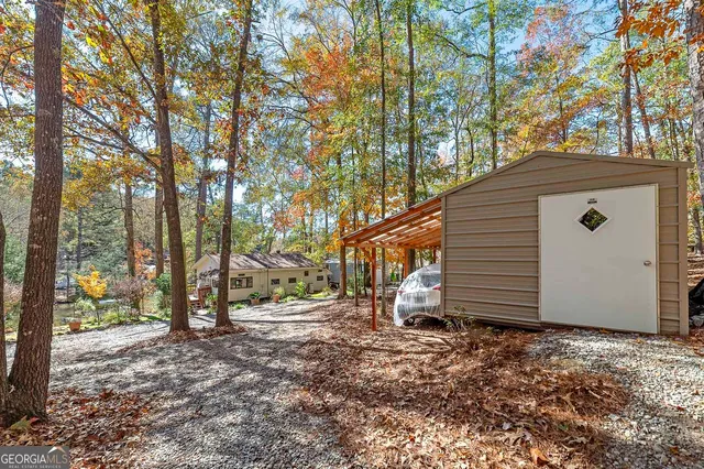 a backyard of a house with table and chairs