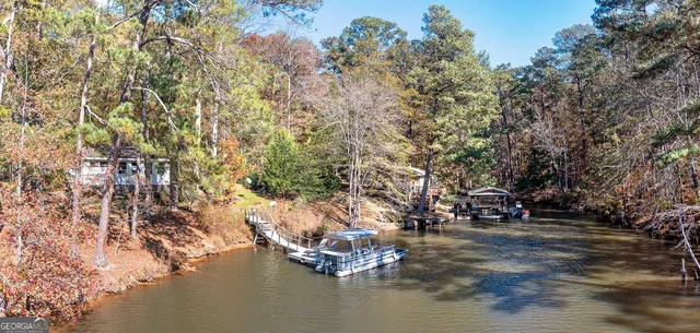 a view of a lake with wooden deck
