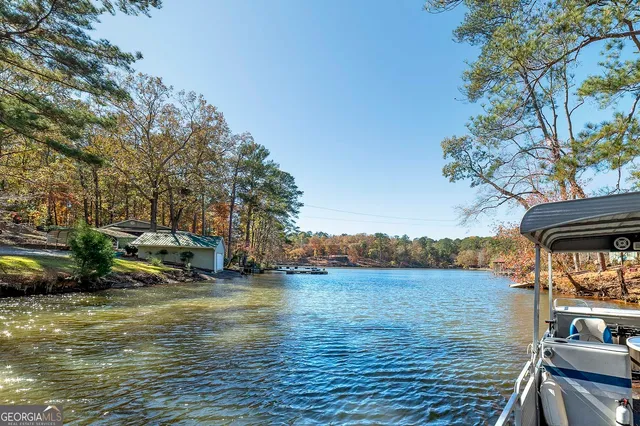 a view of a balcony with chairs and wooden floor