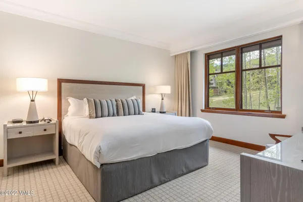 a bedroom with a large bed and a window