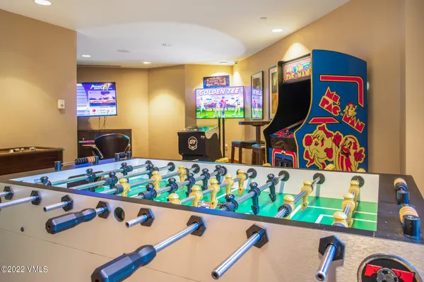 a room with pool table and flat screen tv