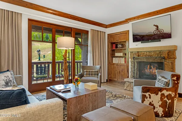 a living room with furniture and a floor to ceiling window