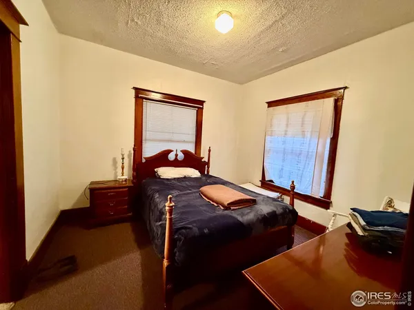 a bedroom with two beds and a dresser