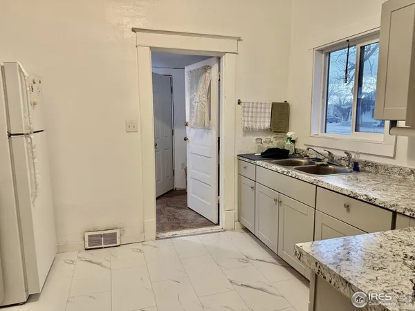 a spacious bathroom with a granite countertop sink and a mirror