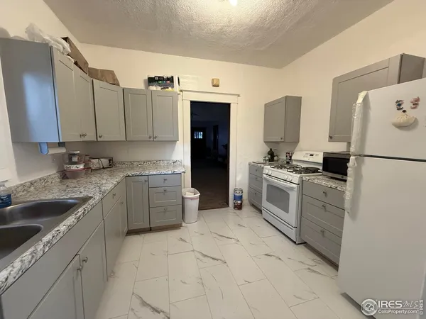 a kitchen with a sink stove and refrigerator