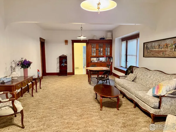 a living room with furniture a window and a chandelier