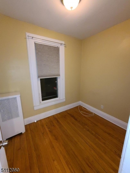 157 Valley Road Montclair, NJ 07042 - Photo 12 of 14 a view of empty room with wooden floor and fireplace