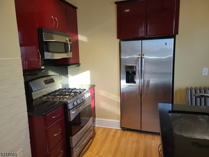 157 Valley Road Montclair, NJ 07042 - Photo 2 of 14 a kitchen with stainless steel appliances granite countertop a refrigerator stove and microwave