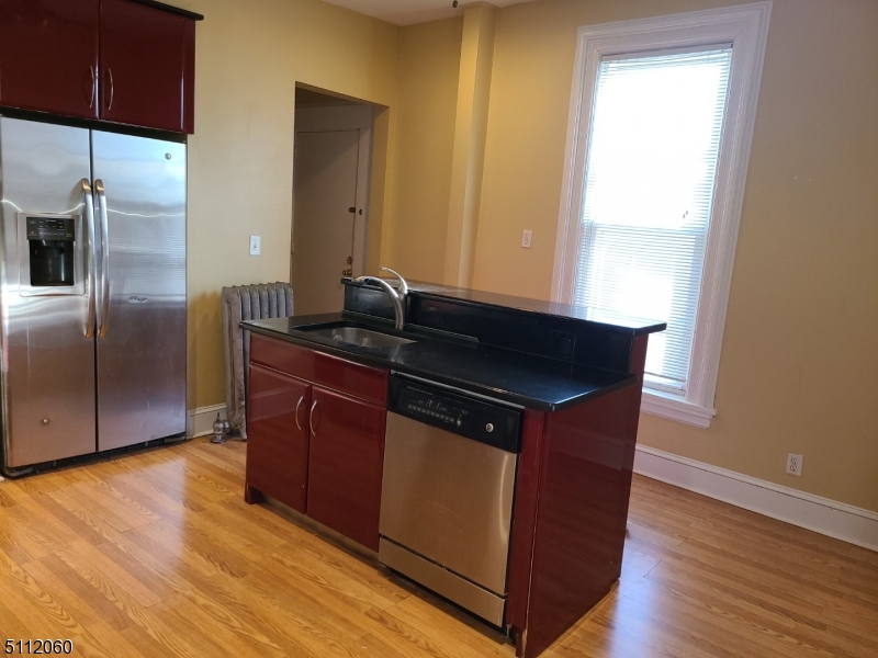 157 Valley Road Montclair, NJ 07042 - Photo 3 of 14 a kitchen with wooden floors and wooden cabinets