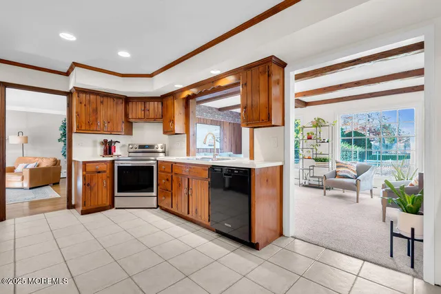 a kitchen with stainless steel appliances kitchen island granite countertop a refrigerator and a stove top oven