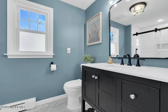 a bathroom with a toilet and shower