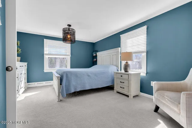 a spacious bedroom with a bed and a cabinets