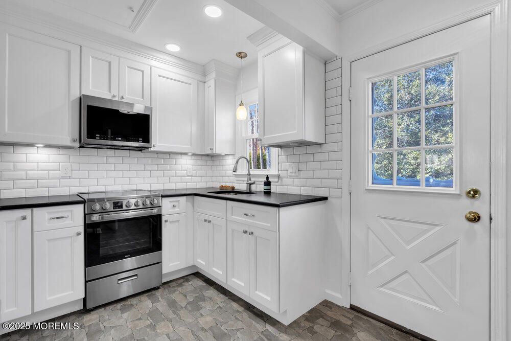 1798 Todd Road Toms River, NJ 08755 - Photo 41 of 61 a kitchen with stainless steel appliances granite countertop a stove and a microwave