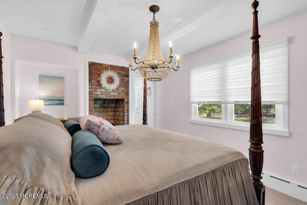 1798 Todd Road Toms River, NJ 08755 - Photo 47 of 61 a bedroom with a bed and a chandelier